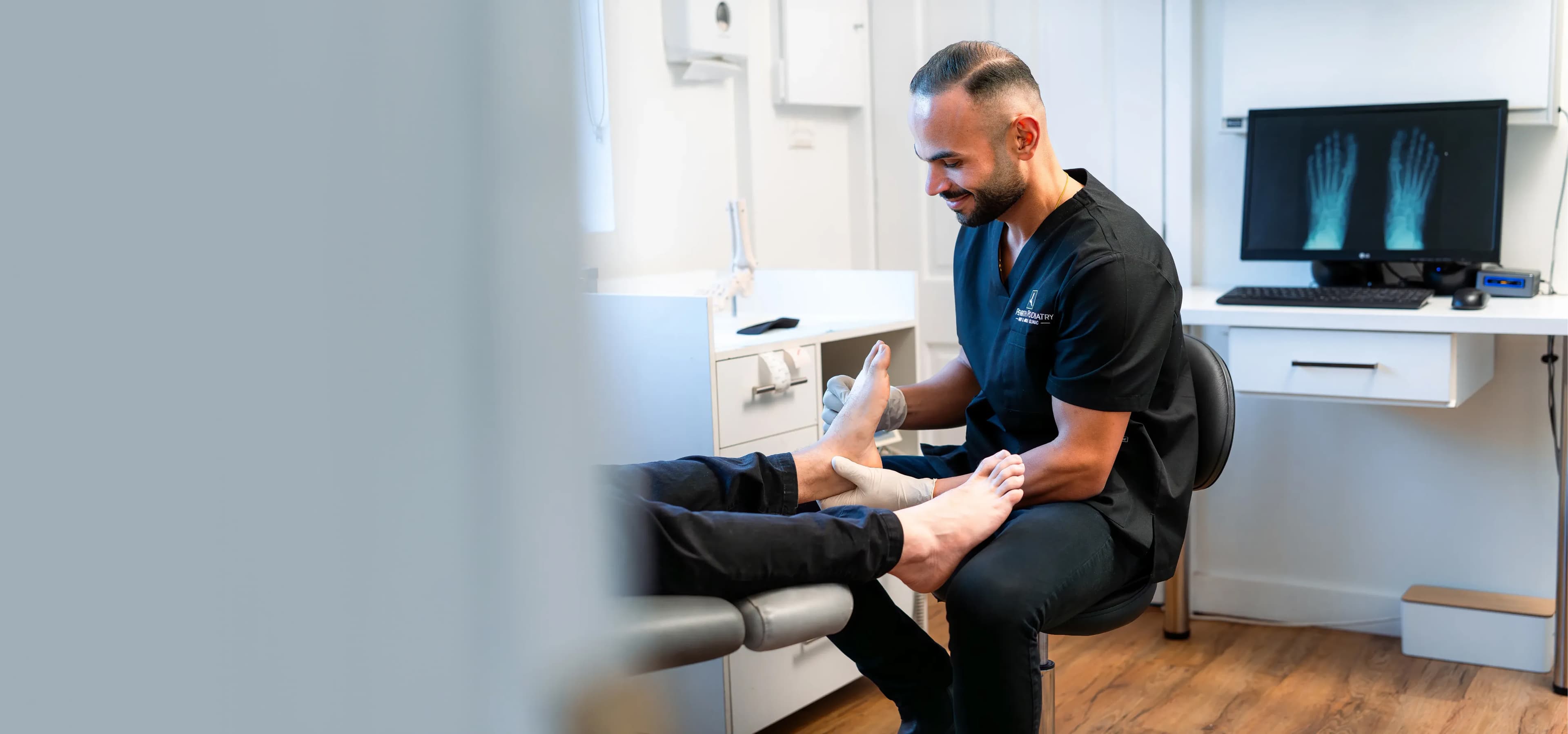 Podiatrist examining a patient's foot with X-ray imaging at Penrith Podiatry Foot and Ankle Clinic