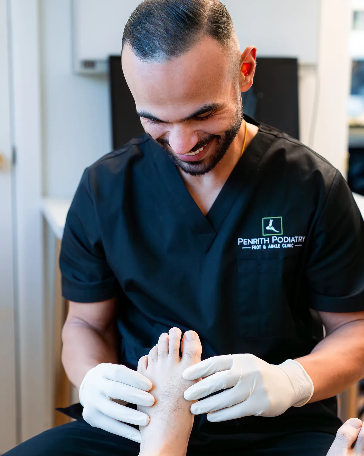 Penrith Podiatry podiatrist carrying out a hands-on foot and ankle assessment in the clinic