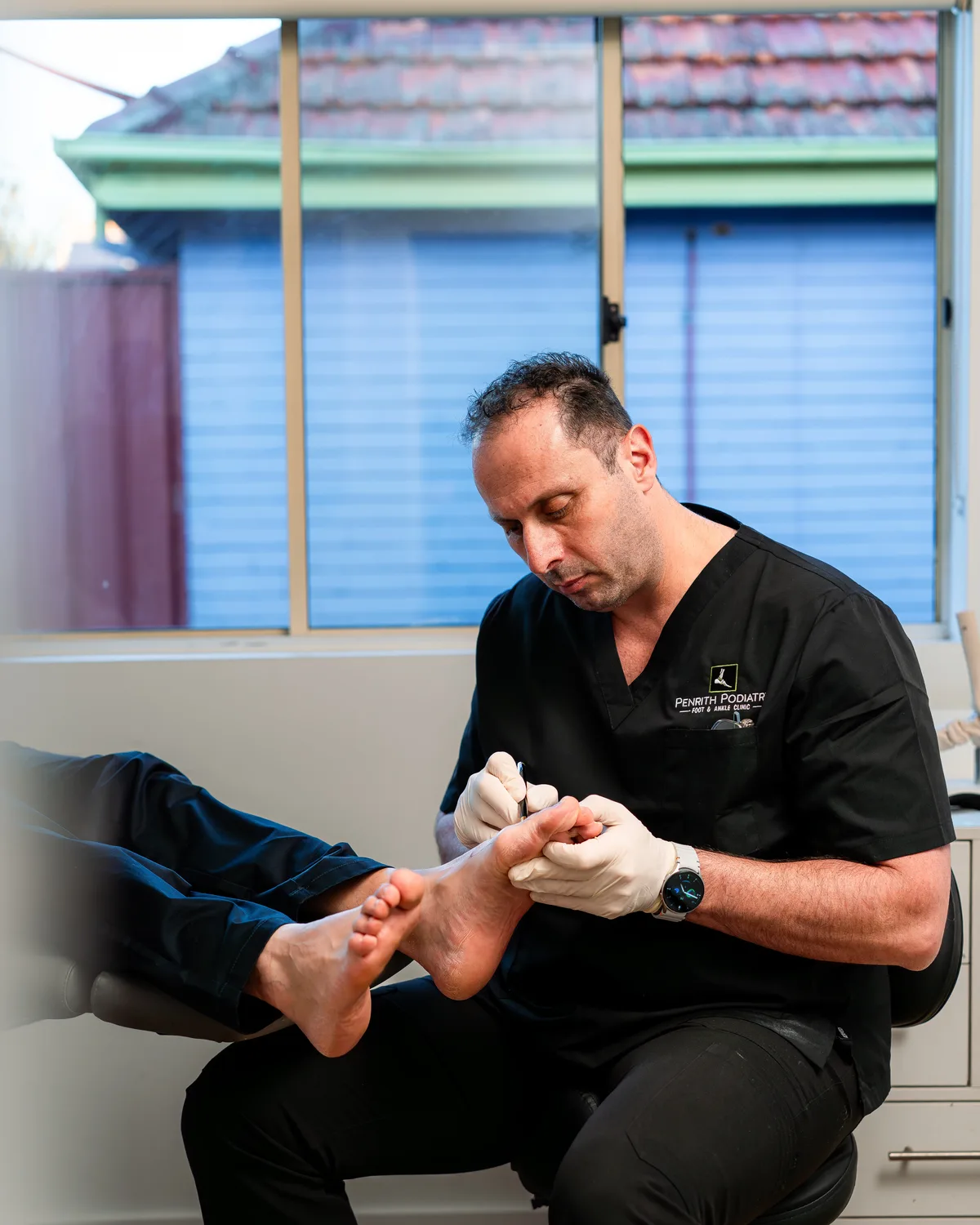 Podiatrist treating a patient's foot at Penrith Podiatry Foot and Ankle Clinic