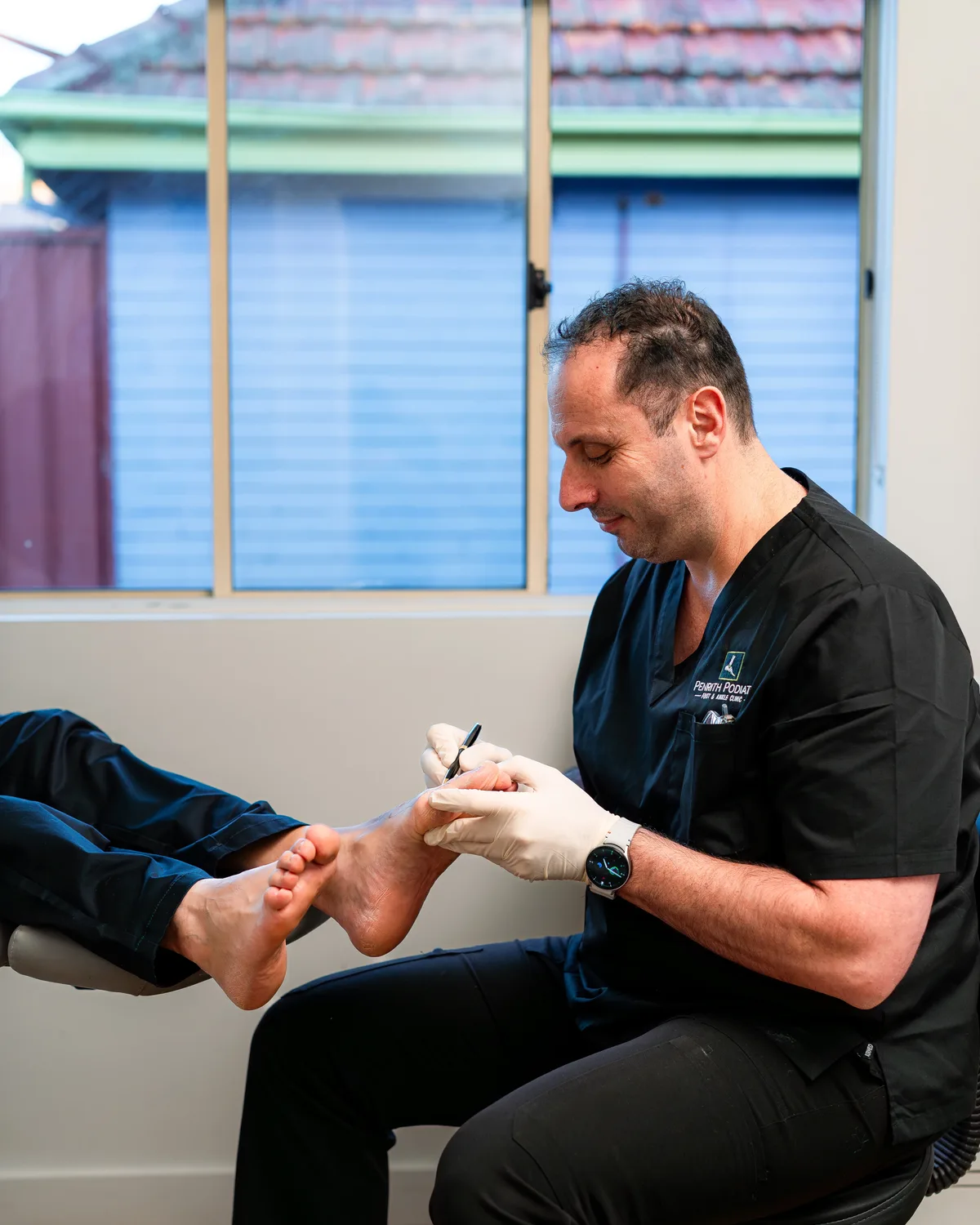 Podiatrist treating a patient's toes at Penrith Podiatry Foot and Ankle Clinic