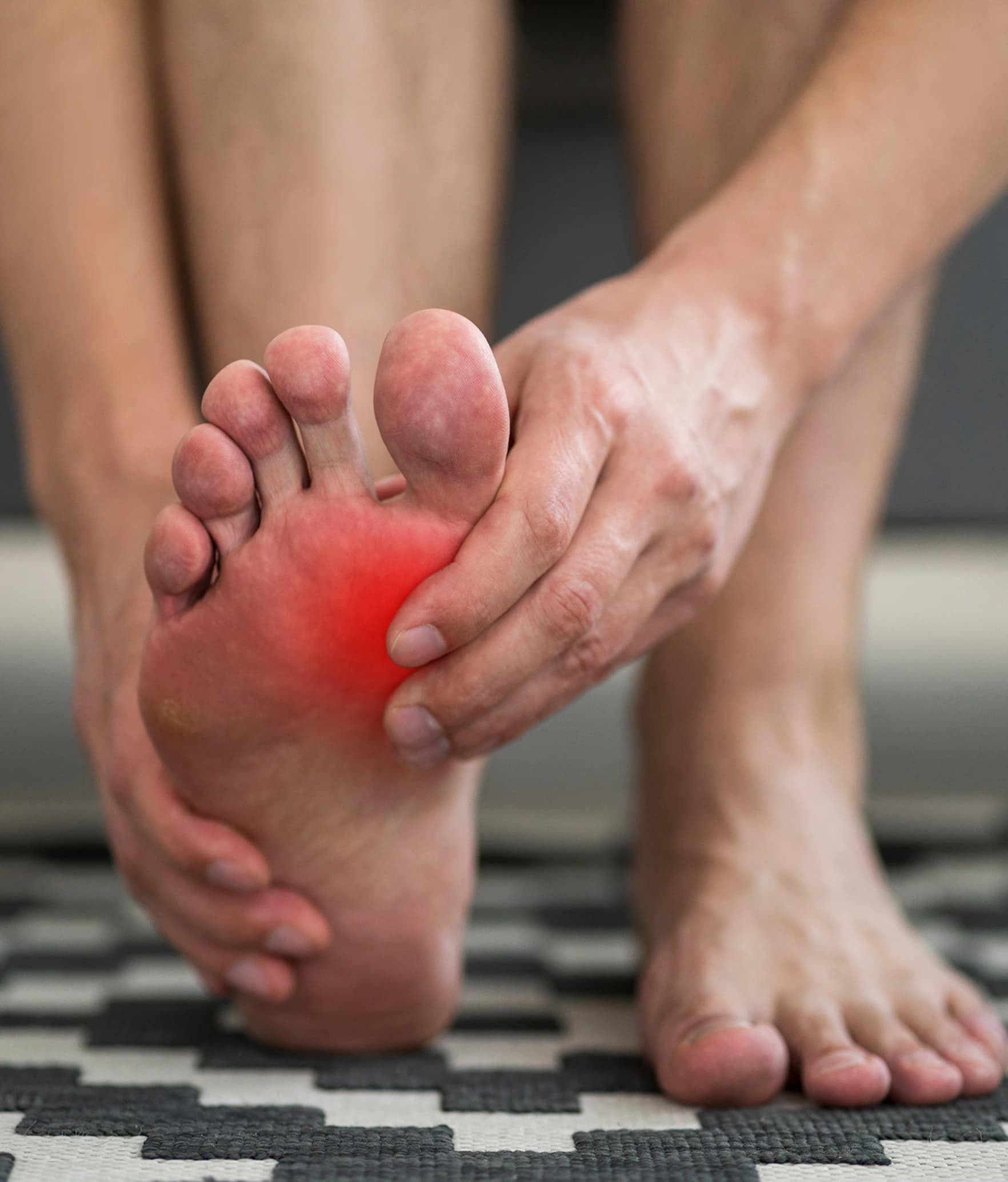 The ball of the foot highlighted, where a plantar plate tear causes pain